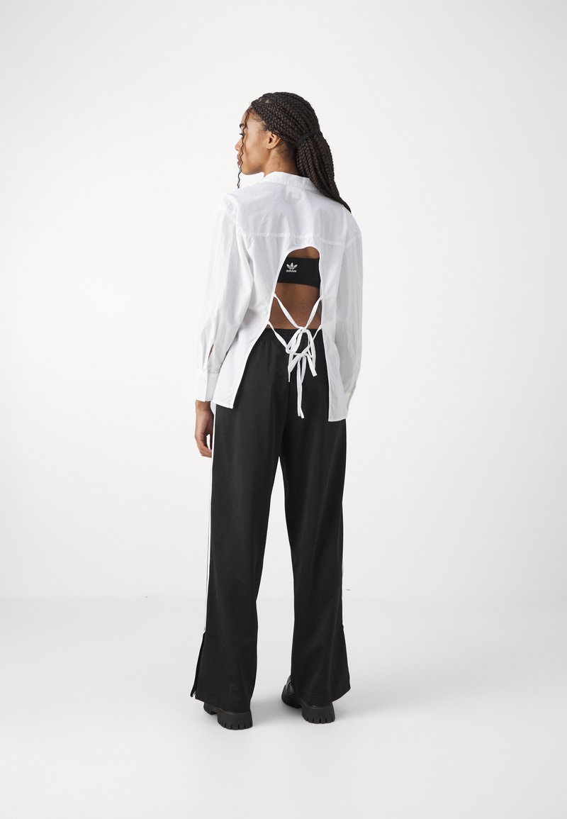 adidas Originals adidas Originals FBIRD LOOSE - Tracksuit bottoms - black im Angebot
