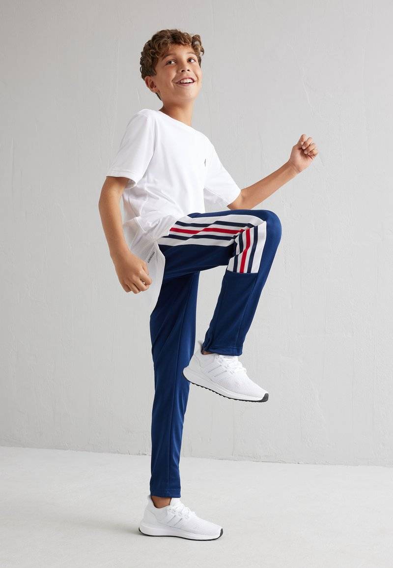 adidas Performance adidas Performance TIRO NATIONS PACK UNISEX - Tracksuit bottoms Saisonschlussverkauf