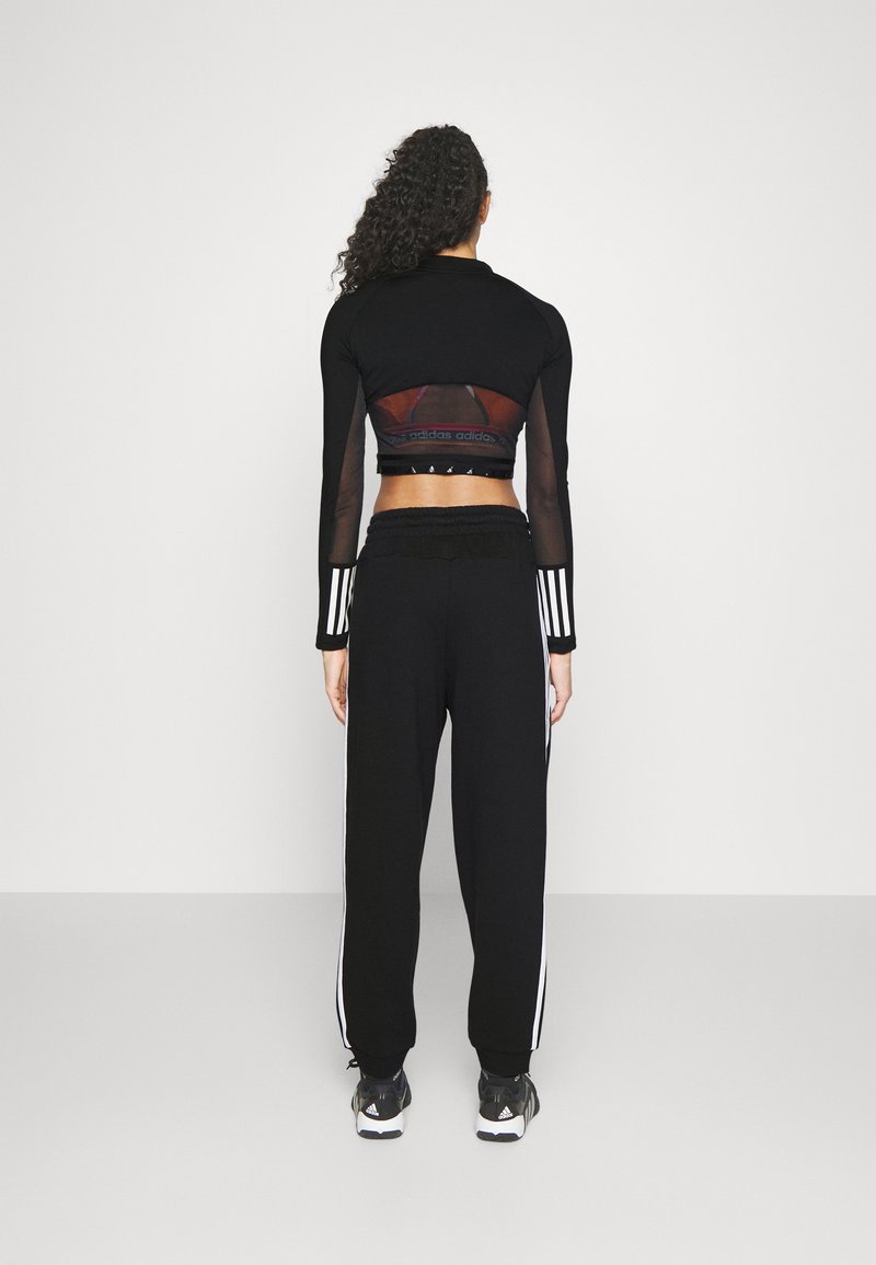 adidas Sportswear adidas Sportswear ESSENTIALS 3-STRIPES LOOSE-FIT - Tracksuit bottoms Große Rabatte
