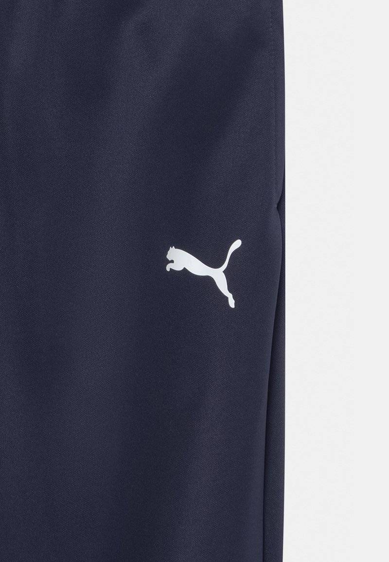 Puma Puma TEAMRISE POLY TRAINING UNISEX - Tracksuit bottoms Exklusivangebot