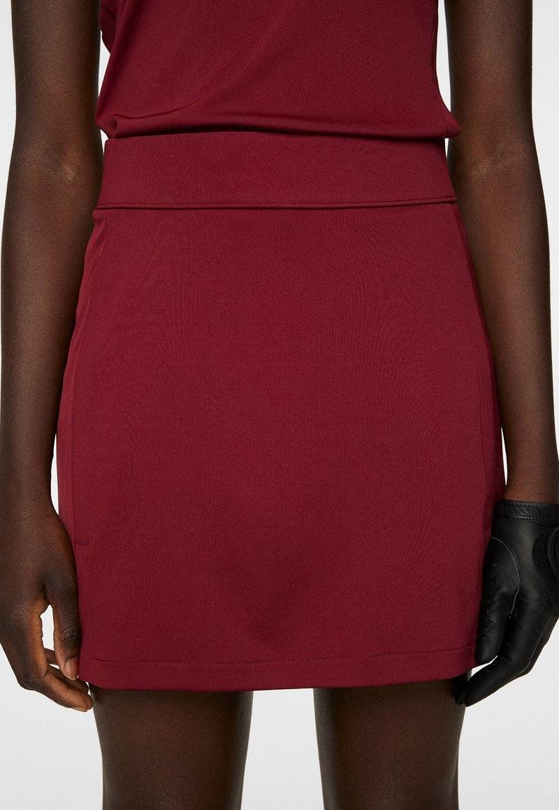 J.LINDEBERG Sports J.LINDEBERG Sports AMELIE MID - Sports skirt - cabernet Super Sparpreis