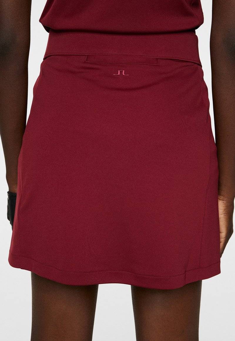 J.LINDEBERG Sports J.LINDEBERG Sports AMELIE MID - Sports skirt - cabernet Super Sparpreis