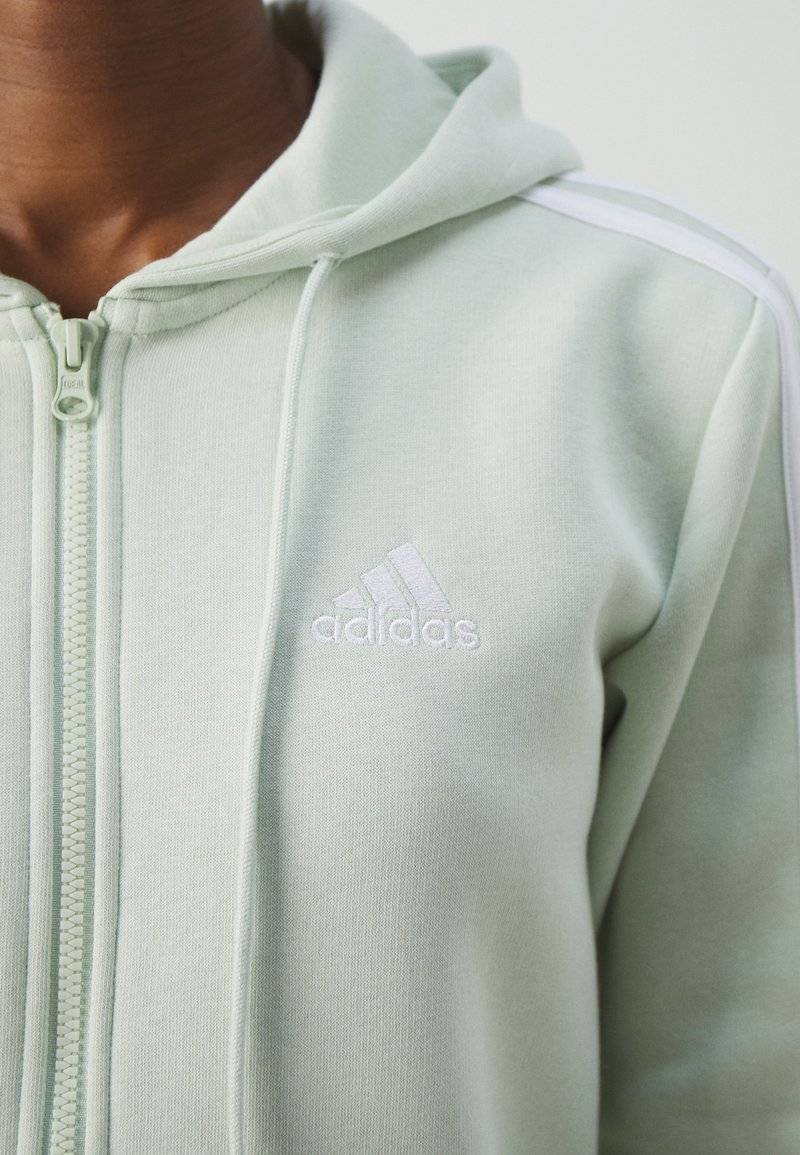 adidas Sportswear adidas Sportswear ESSENTIALS 3 STRIPES FULL ZIP HOODIE - Zip-up sweatshirt - linen green Bis zu 55% Rabatt